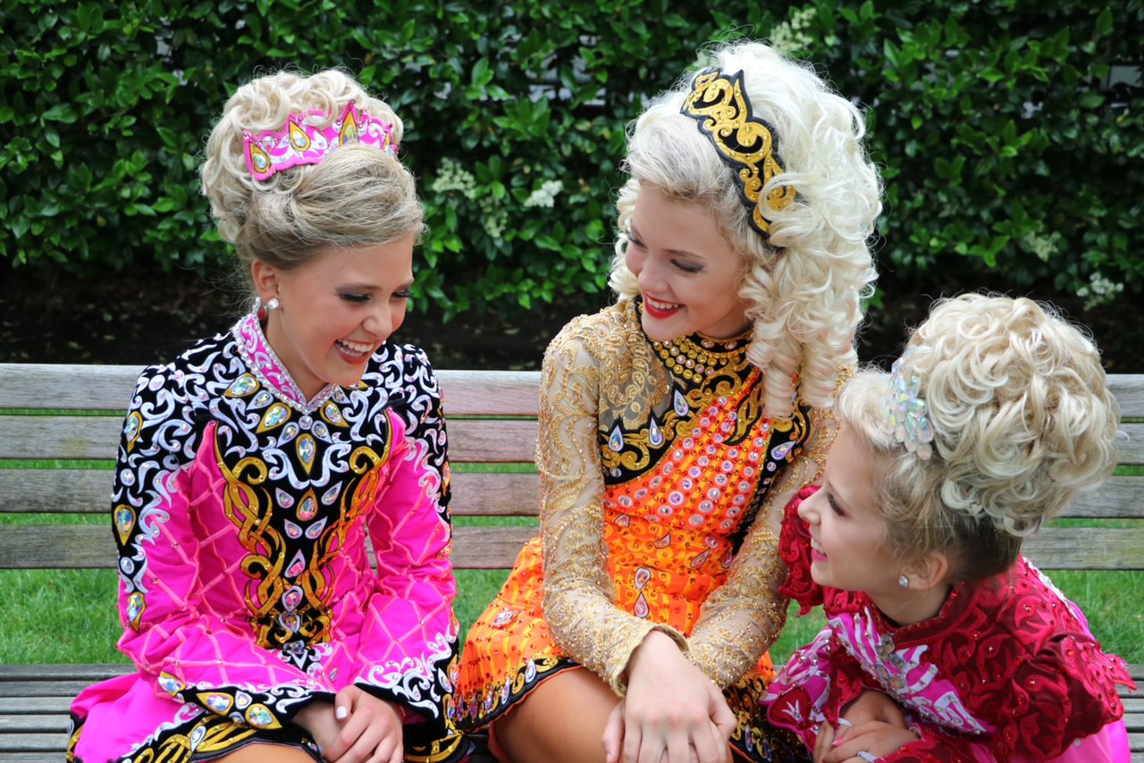 Young Irish dancers in costume, smiling together
